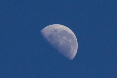 Close up of the half-moon at blue sky